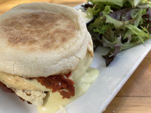 Prosciutto eggs Benedict sandwich with mixed greens at Watercourse Foods in Denver