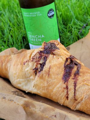 Counting chocolate croissant with kombucha at the park at Black Rabbit in Edinburgh