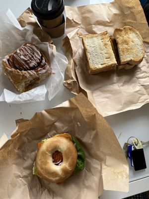 salmon and cream cheese bagel, bacon and nae egg breakfast sandwich and cinnamon roll  at Black Rabbit in Edinburgh