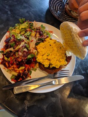 Egg & bacon roll with beet salad on the side. Best vegan scramble in Scotland. at Black Rabbit in Edinburgh