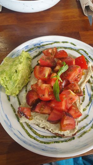 Tostada con mix de tomates, queso vegano de anacardos y pesto at The Fix Specialty Coffee in Madrid
