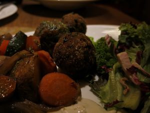 Meatless “chicken“and mushroom balls with oven-roasted vegetables, basil pesto and homemade tofunnaise  at Maitrea in Prague
