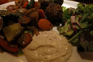 Meatless “chicken“and mushroom balls with oven-roasted vegetables, basil pesto and homemade tofunnaise  at Maitrea in Prague