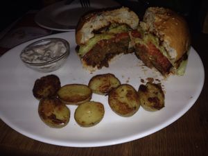 Burger with a side of potatoes!  at Maitrea in Prague