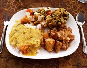 Basmati rice with dahl, aloo gobi (potatoes and cauliflower), spinach pakoras, and mixed veggie tofu paneer. We also got a bowl of broccoli soup to start and a cranberry nut ball for dessert. Photo taken in February 2018. at Govinda's in Toronto