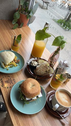 (Left to right) breakfast bao, wrap, beetroot and feta bagel, the pineapple and mango lemonade, the caffe latte  at Avocado Spot in Gdansk