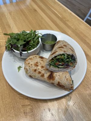 Mediterranean Wrap- hummus, spicy herb sauce, red pepper pistachio spread, cucumber, olives, artichoke, organic spring mix, lemon oregano vinaigrette. Side salad included.  at True Food Kitchen in Jacksonville