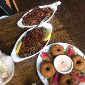 Sleek and mujadara, each topped with caramelized onions, and a falafel platter with pickled vegetables.  at Kassab's Restaurant in Pittsburgh