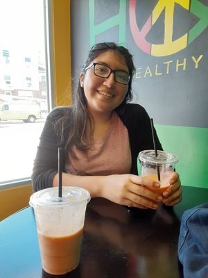 Non vegan friend enoughing her smoothie at The Healthy Hippy in Newark