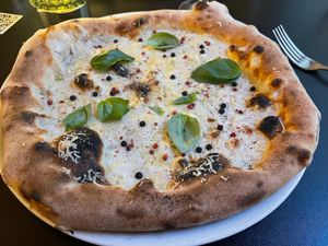 Cacio E Pepe:
Cashew mozzarella, gondino pecorino, salted green peppers, pink pepper, freshly grounded black pepper
 at Plant A Pizza in Ghent