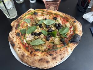The Med. Tomato sauce, cashew mozzarella, olive mix, marinated artichokes, oregano, fresh basil  at Plant A Pizza in Ghent