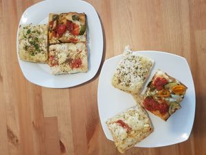 Quarters of different pizzas - Detroit style at Plant A Pizza in Ghent