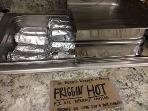 Friggin' HOT is no joke! Grab a paper napkin for insulation before you go in, then use it to wipe your messy face. at Mountain Avenue Market in Fort Collins