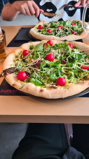 Vegan pizza with courgette 'spaghetti 'with sheese and  salad. A really big bizza! at Superfood Healthy Food Factory in Split