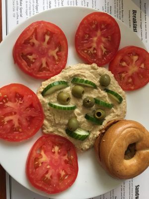 Hummus platter with olives, cucumber, tomato. With bagel instead of bread (vegan) at Bohemia Bagel in Prague