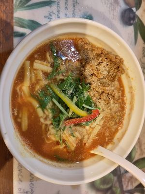 Tomato curry soup with extra soy meat and vegan cheese, I'm happy I got the extra toppings otherwise it's basically just noodles and broth. at Fuku Noki in Sapporo