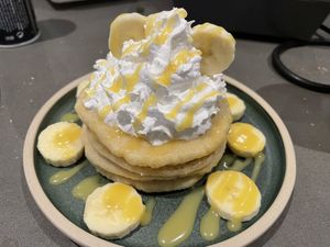 Pancakes with banana and homemade toffee sauce 💚 and vegan whipped cream 🌱  at The Greenhouse in Fleet