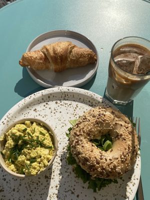 Egg salad bagel, scrambled tofu, chocolate croissant, iced coffee  at Plant Base in Berlin