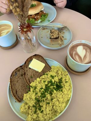Scrumbled tofu, snickers cake, bagel with salmon and hot chocolate 😋  at Plant Base in Berlin