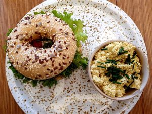 Bagel with hummus and dried tomatoes and tofu scramble 🥰 at Plant Base in Berlin