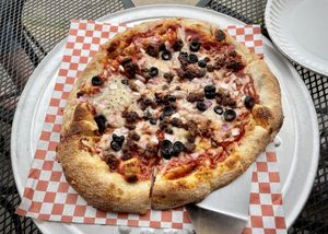 Dairy free cheese, plant based hamburger, olives, onions and the delicious house red sauce    at Brick Oven Pizzeria in Omaha