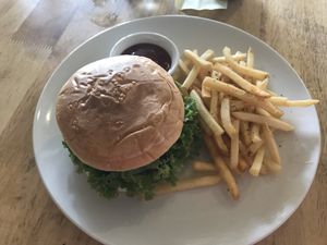Falafel burger comes with chips and ketchup  at CV Cafe in Kampot