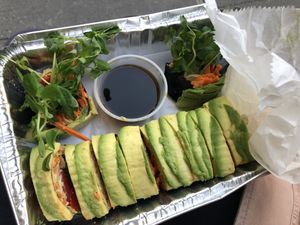 Raw sushi rolls: julienne veggies, walnut pate, nori sprouts, ginger, avocado 
  at Peacefood Cafe - Uptown in New York City