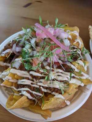 Big pile of nachos with tasty lentil/walnut topping. at Passiflora in Rincon