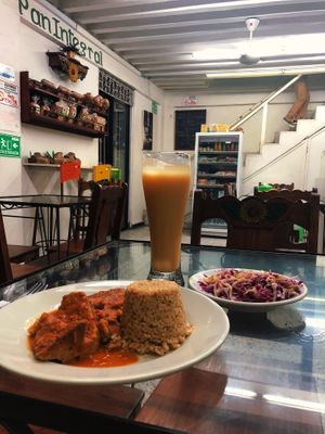 Chickpea Mole with veggie rice, Pineapple rice juice, and a side salad at Girasoles Restaurante Vegetariano in Cartagena