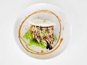 Tempura Veggie Bao
Tempura fried kumara, carrot, mushrooms, sesame and teriyaki sauce and mayonnaise. Soft steamed bun. Salad dressing is GF and DF but contains Nuts at Table of Munchies in Christchurch