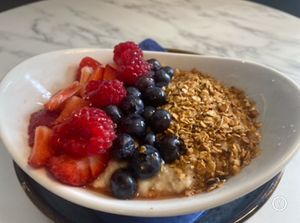 Homemade granola with dairy-free vanilla yoghurt and fresh fruit at Skinny Batch Bakery in Lusk