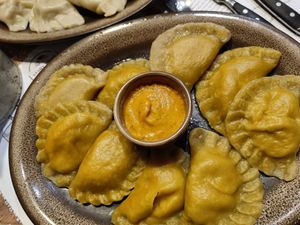 Red lentil and pepper pierogi with carrot dough, with spicy pepper sauce at Pierogarnia Stary Młyn in Gdansk