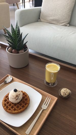 Waffel with ice cream & turmeric latte and chocolate ball. at 7T Healthy in Bu Quwah