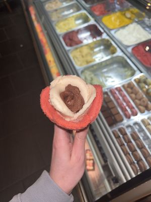 Chocolate, banana and strawberry sorbet in a cone.  at Amorino - Carmelitas in Porto