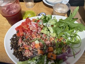 Quinoa & Lentil Bowl with Tahini on top and Celery Juice  at Aroma in Tel Aviv