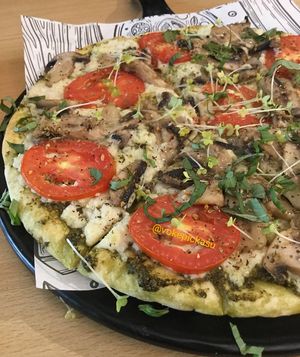 Pesto with yumm vegan cheese on pizza at La Cane Bistro in Mumbai