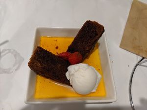 Vegan sticky date pudding with vanilla ice cream at Caruso's in Gymea