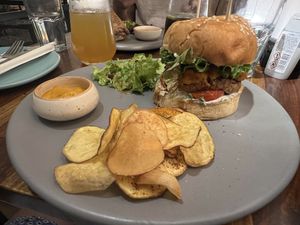 Burger with chips (crisps)  at Greenr Cafe in New Delhi