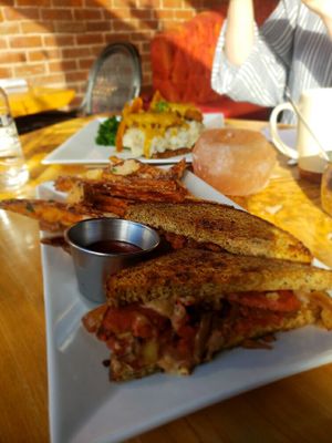 Rubin with open face seitan sandwich in the back  at ION - It's Only Natural Restaurant in Middletown