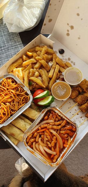 Munch box with shredded chicken, noodles, salt and chili chips, satay, spring rolls and sauces at Puti Vegan Cafe in Glasgow