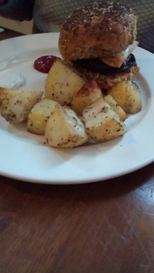 Burger with roast potatoes  at Goji Vegetarian Cafe and Deli in York