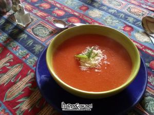 Tomato soup with grated cheese and a couple of spearmint leaves. at Quinua y Amaranto in Bogota