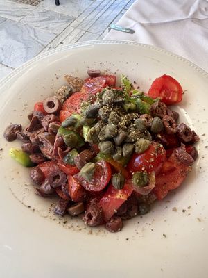 Dakos Cretan salad with barley, cherry tomatoes, green peppers, olives and capers.  at Gods' Restaurant - Οινομαγειρείο των Θεών in Athens
