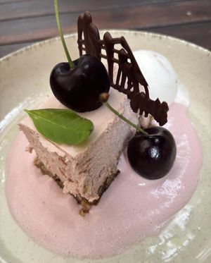 Cherry cheesecake on a bottom of dates and nuts, with cherry saus, yoghurt ice cream and chocolate   at De Levensboom in Hasselt