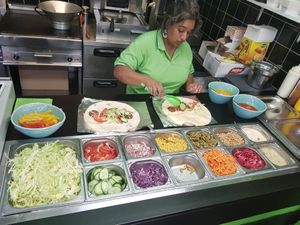 Preparing falafel with fresh ingredients at Big Burger in Amsterdam