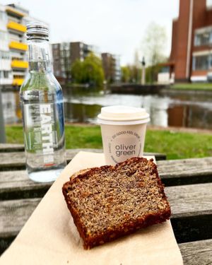 To-Go; Banana Bread, cappuccino with sprout milk and water   at Oliver Green - East in Amsterdam