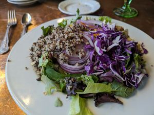 Farmer's Market Salad (vegan) - greens, quinoa, mandarin oranges, cabbage onions, slivered almonds, oil and vinegar at Madonna Inn in San Luis Obispo