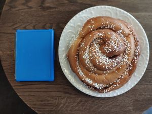 Giant cinnamon bun, Kindle is in there for scale. at Cafe Husaren in Gothenburg