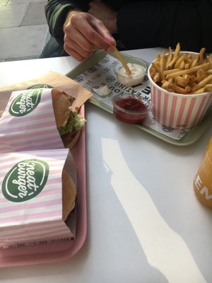 Two vegan chicken burgers with chips, ketchup, Mayo and a passion fruit ade at Neat Burger - Oxford Circus in London
