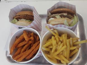 Sweet potato fries, 'cheezy' fries, no-meat and no-chicken burgers.

Packaging is made out of paper, but contains a plastic/laminated lining (for grease, I guess). at Neat Burger - Oxford Circus in London